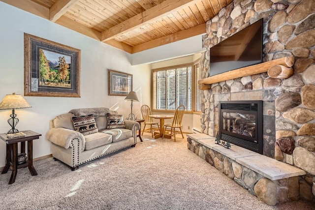 carpeted living room featuring beamed ceiling, a stone fireplace, baseboards, and wood ceiling