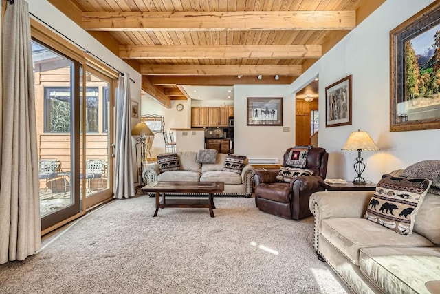 living room featuring beam ceiling, plenty of natural light, light colored carpet, baseboard heating, and wooden ceiling