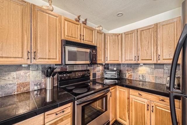 kitchen featuring light brown cabinetry and stainless steel appliances