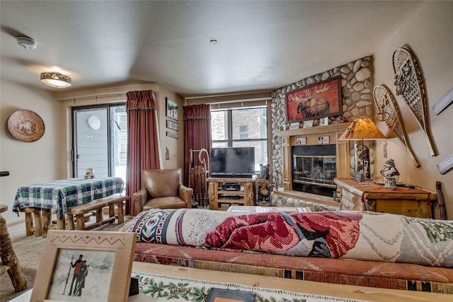 100 S Park Ave Unit E113, Breckenridge, CO 80424 - carpeted living room with plenty of natural light and a stone fireplace