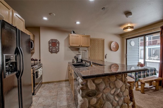 100 S Park Ave Unit E113, Breckenridge, CO 80424 - kitchen with appliances with stainless steel finishes, light brown cabinets, dark countertops, a peninsula, and a breakfast bar area