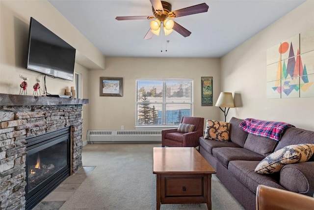 300 Base Camp Cir Unit 214, Granby, CO 80446 - living room with ceiling fan, baseboard heating, carpet flooring, and a stone fireplace
