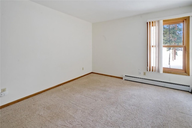 spare room featuring baseboards, baseboard heating, and carpet