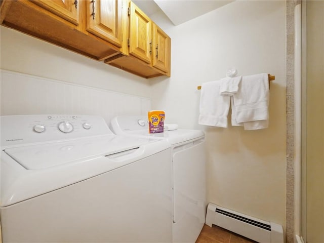 clothes washing area featuring tile patterned flooring, washer and clothes dryer, cabinet space, and baseboard heating