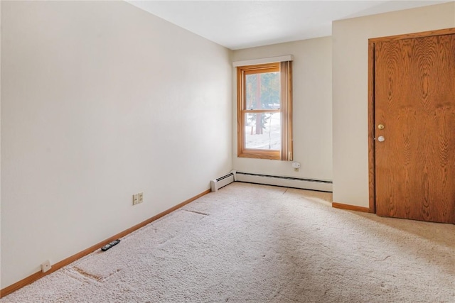 carpeted spare room featuring baseboards and a baseboard heating unit