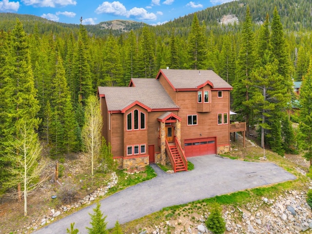 322 Davis Ct, Breckenridge, CO 80424 - chalet / cabin featuring a view of trees, a garage, driveway, a mountain view, and stairs