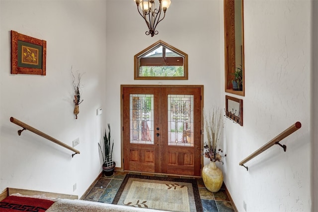 322 Davis Ct, Breckenridge, CO 80424 - foyer entrance with a chandelier, a towering ceiling, and stone finish flooring