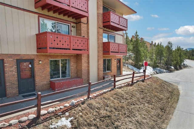 180 Evergreen Rd Unit 102, Dillon, CO 80435 - view of property exterior featuring brick siding, a balcony, and fence