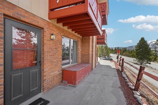 180 Evergreen Rd Unit 102, Dillon, CO 80435 - doorway to property with fence, brick siding, and a mountain view