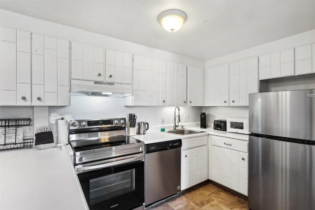 180 Evergreen Rd Unit 102, Dillon, CO 80435 - kitchen with stainless steel appliances, light countertops, under cabinet range hood, and a sink