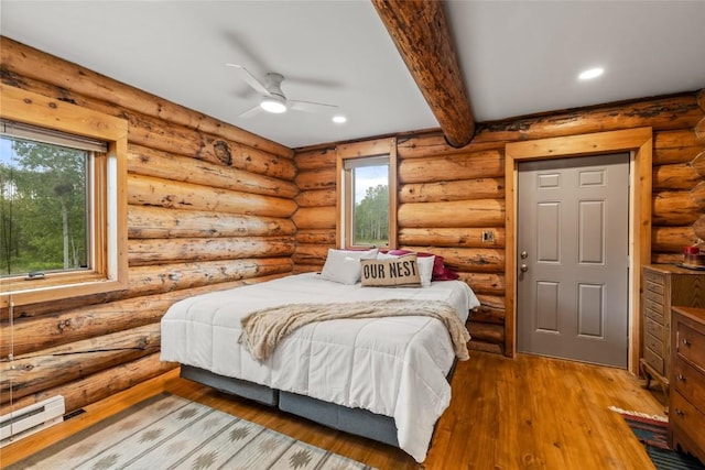 33000 Maricopa Trl, Oak Creek, CO 80467 - bedroom featuring wood-type flooring, beamed ceiling, a baseboard radiator, recessed lighting, and rustic walls