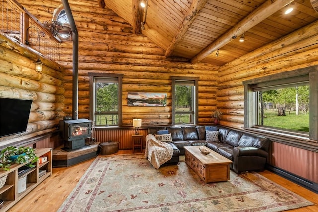 33000 Maricopa Trl, Oak Creek, CO 80467 - living room featuring a wooden ceiling with exposed beams, plenty of natural light, hardwood / wood-style floors, a wood stove, and high vaulted ceiling