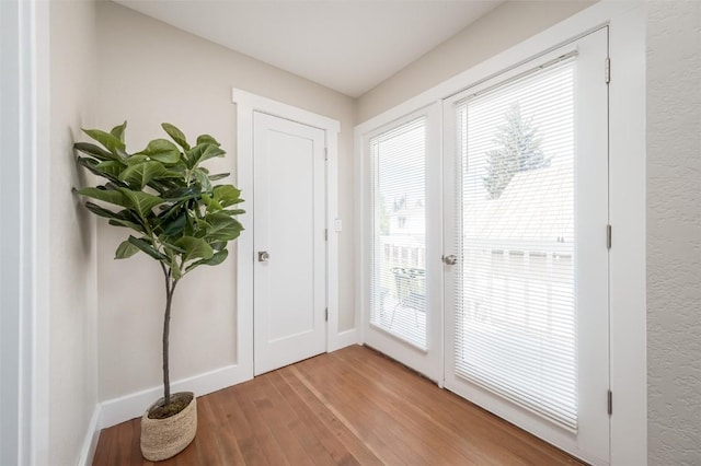 464 8th St, Steamboat Springs, CO 80487 - doorway featuring light wood-style flooring, baseboards, and french doors