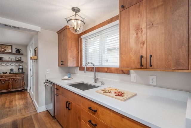 464 8th St, Steamboat Springs, CO 80487 - kitchen featuring a sink, light countertops, stainless steel dishwasher, wood-type flooring, and brown cabinetry