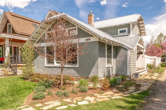 464 8th St, Steamboat Springs, CO 80487 - view of property exterior with a chimney and metal roof