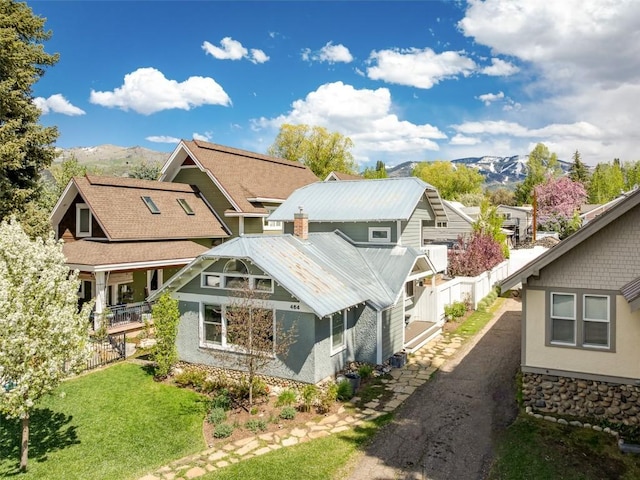 464 8th St, Steamboat Springs, CO 80487 - back of house with a mountain view, a residential view, a porch, and metal roof