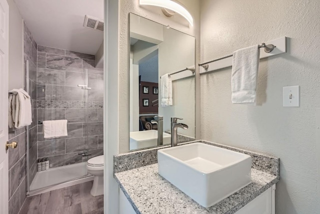 412 S Main St Unit 215, Breckenridge, CO 80424 - full bathroom featuring toilet, vanity, wood finished floors, and a stall shower