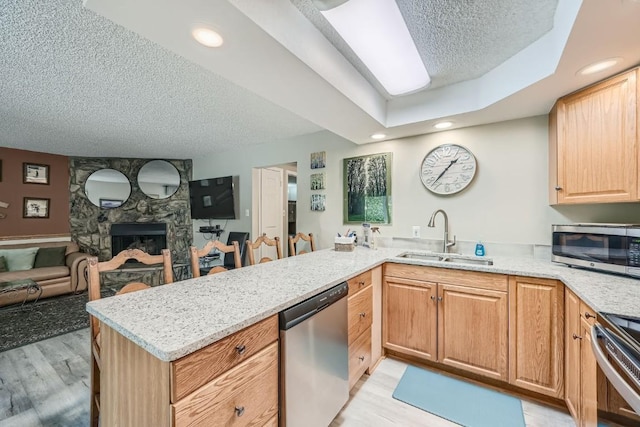 412 S Main St Unit 215, Breckenridge, CO 80424 - kitchen featuring light wood-style flooring, a textured ceiling, appliances with stainless steel finishes, and a sink