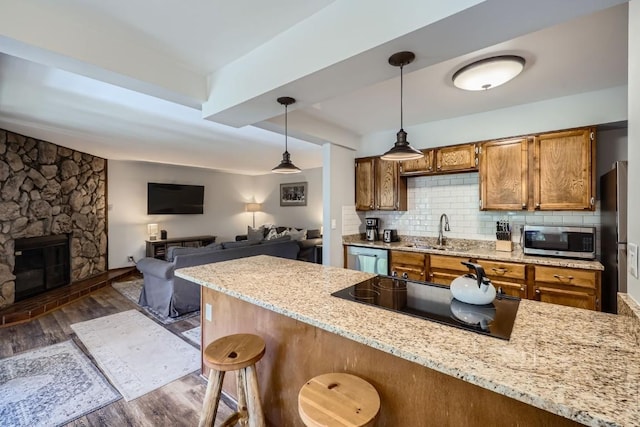 325 Four Oclock Rd Unit E202, Breckenridge, CO 80424 - kitchen with stainless steel appliances, dark wood finished floors, brown cabinets, and a breakfast bar area