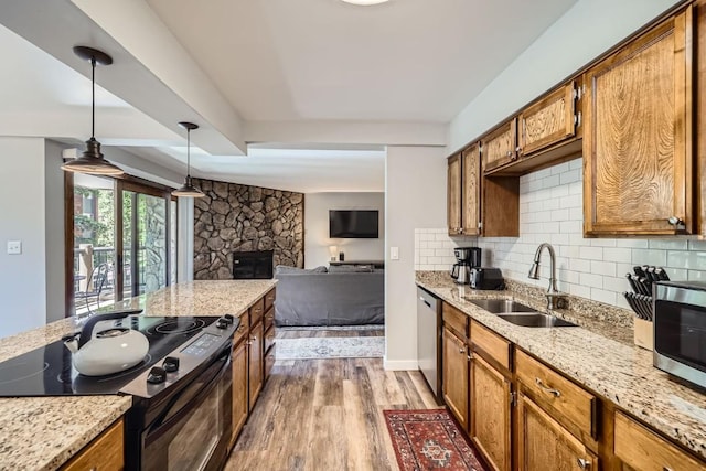 325 Four Oclock Rd Unit E202, Breckenridge, CO 80424 - kitchen featuring stainless steel appliances, wood finished floors, open floor plan, and brown cabinets