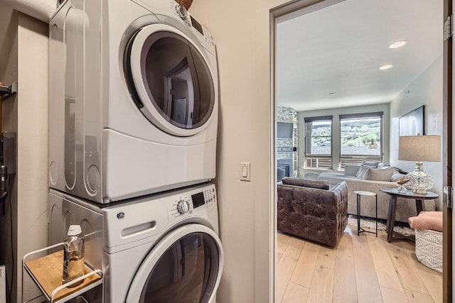 1090 Blue River Pkwy Unit 204, Silverthorne, CO 80498 - laundry area featuring stacked washer / drying machine and light wood-style flooring