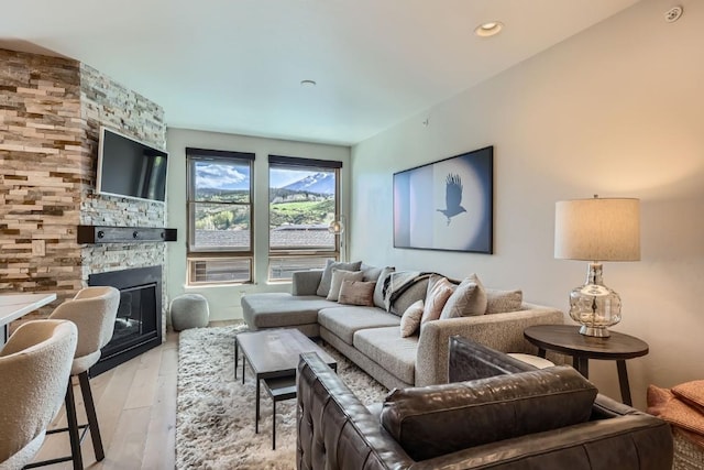 1090 Blue River Pkwy Unit 204, Silverthorne, CO 80498 - living area with a stone fireplace and light wood finished floors