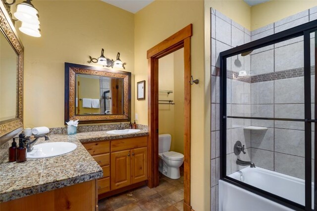 2760 Burgess Creek Rd Unit 2, Steamboat Springs, CO 80487 - bathroom with toilet, bath / shower combo with glass door, a sink, and double vanity