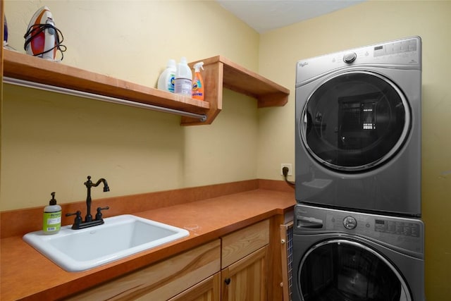 2760 Burgess Creek Rd Unit 2, Steamboat Springs, CO 80487 - washroom featuring cabinet space, stacked washer / dryer, and a sink
