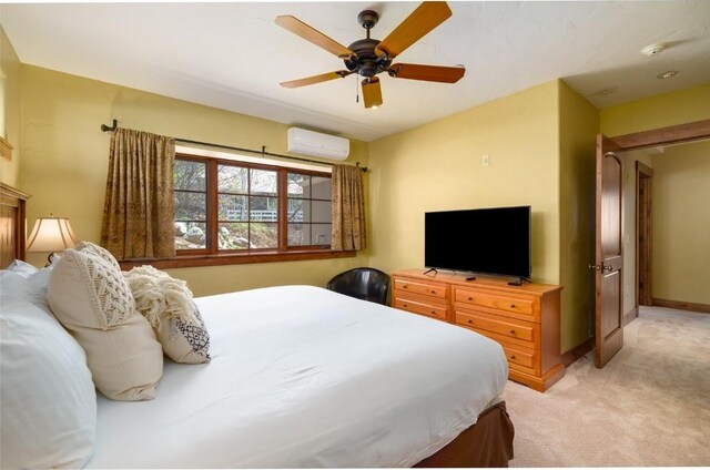 2760 Burgess Creek Rd Unit 2, Steamboat Springs, CO 80487 - bedroom featuring baseboards, a wall mounted air conditioner, light colored carpet, and ceiling fan