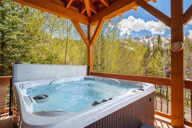 2760 Burgess Creek Rd Unit 2, Steamboat Springs, CO 80487 - deck with a forest view, a hot tub, and a mountain view