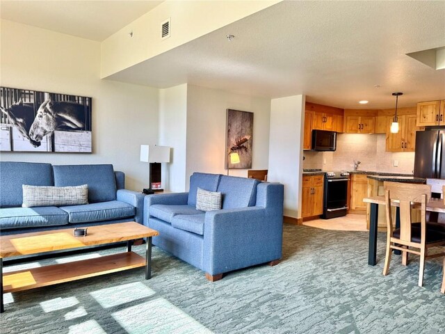 2300 Mount Werner Cir Unit 631, Steamboat Springs, CO 80487 - living room featuring light carpet