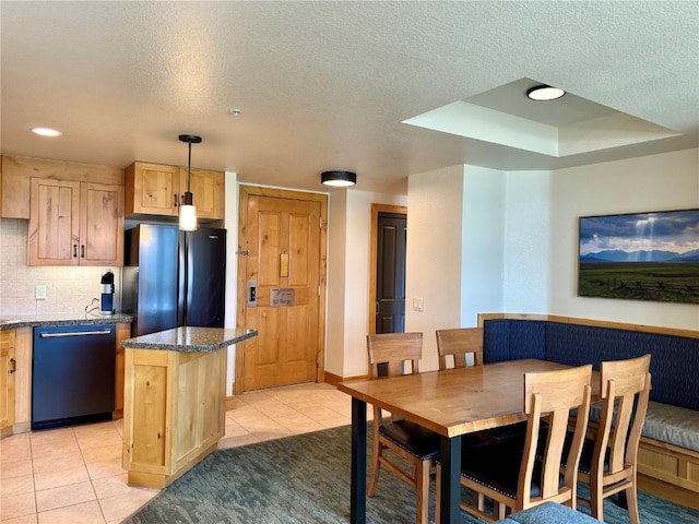2300 Mount Werner Cir Unit 631, Steamboat Springs, CO 80487 - kitchen featuring freestanding refrigerator, dishwasher, light tile patterned floors, a center island, and a raised ceiling