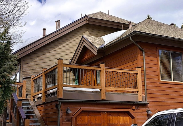 view of home's exterior with a garage and roof with shingles