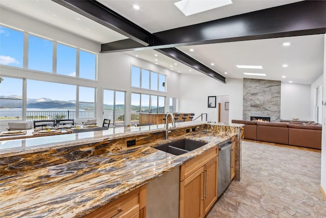 100 Gcr 4104, Granby, CO 80446 - kitchen featuring stainless steel dishwasher, open floor plan, healthy amount of natural light, light stone countertops, and beamed ceiling