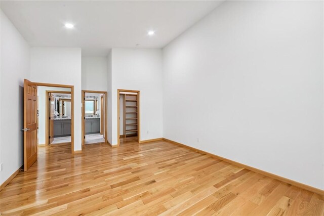 100 Gcr 4104, Granby, CO 80446 - unfurnished bedroom featuring a high ceiling, light wood-style flooring, a walk in closet, and recessed lighting