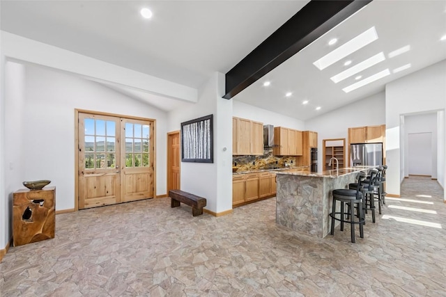 100 Gcr 4104, Granby, CO 80446 - kitchen with vaulted ceiling, light stone finish flooring, stainless steel fridge with ice dispenser, backsplash, and a breakfast bar