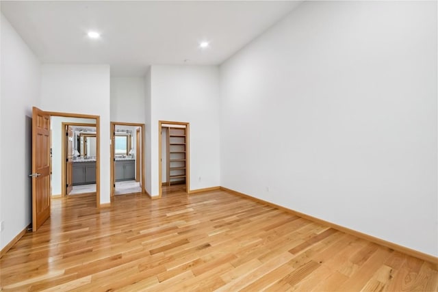 100 Gcr 4104, Granby, CO 80446 - unfurnished bedroom featuring a high ceiling, light wood-style flooring, a walk in closet, and recessed lighting