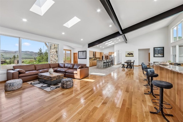 100 Gcr 4104, Granby, CO 80446 - living area with high vaulted ceiling, light wood-type flooring, beam ceiling, a skylight, and recessed lighting