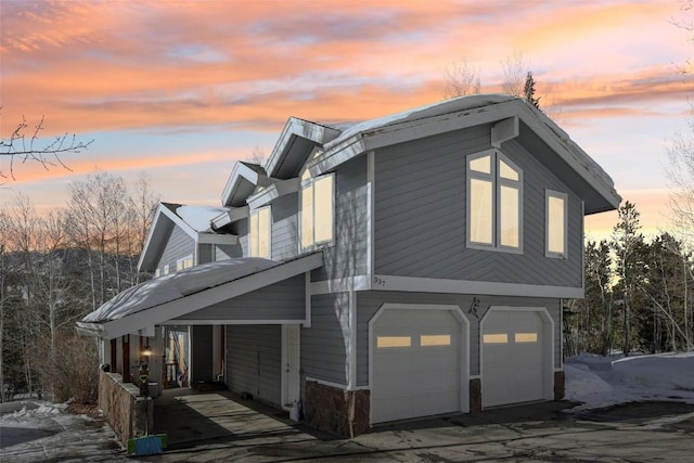 property exterior at dusk with a garage