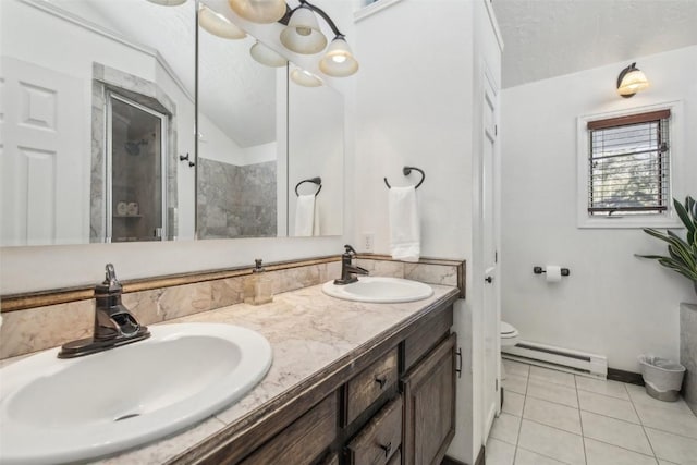 bathroom featuring tile patterned floors, baseboard heating, a stall shower, and a sink
