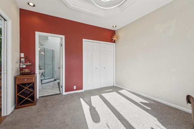 unfurnished bedroom featuring recessed lighting, carpet floors, a closet, baseboards, and ensuite bathroom
