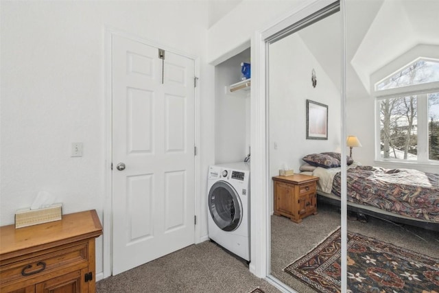 clothes washing area featuring carpet flooring, laundry area, and washer / clothes dryer