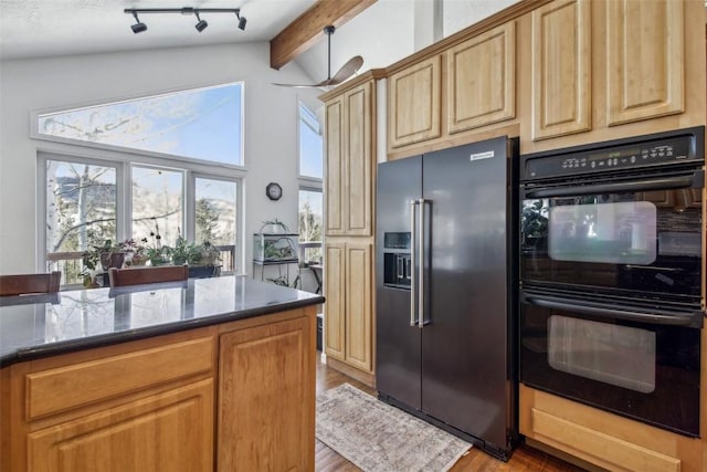 kitchen with high end fridge, wood finished floors, dobule oven black, dark stone counters, and lofted ceiling with beams