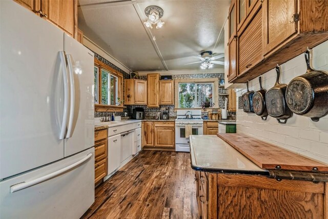 16514 Elkhorn Rd, Como, CO 80432 - kitchen with dark wood-type flooring, a wealth of natural light, a ceiling fan, and white appliances