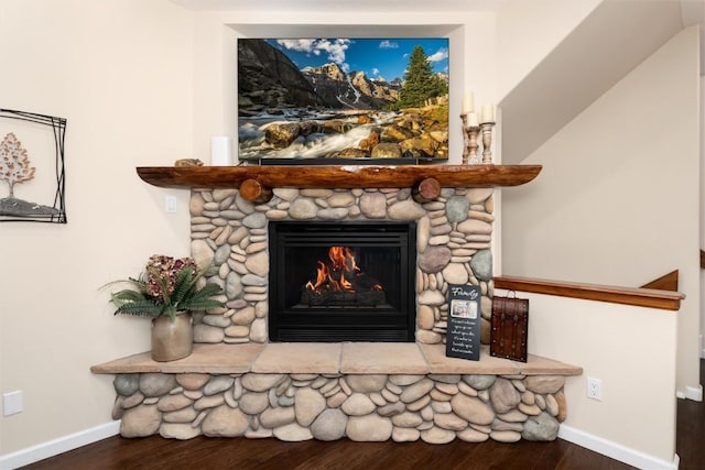 98 Lookout Ridge Dr Unit 98, Dillon, CO 80435 - detailed view of baseboards, wood finished floors, and a stone fireplace