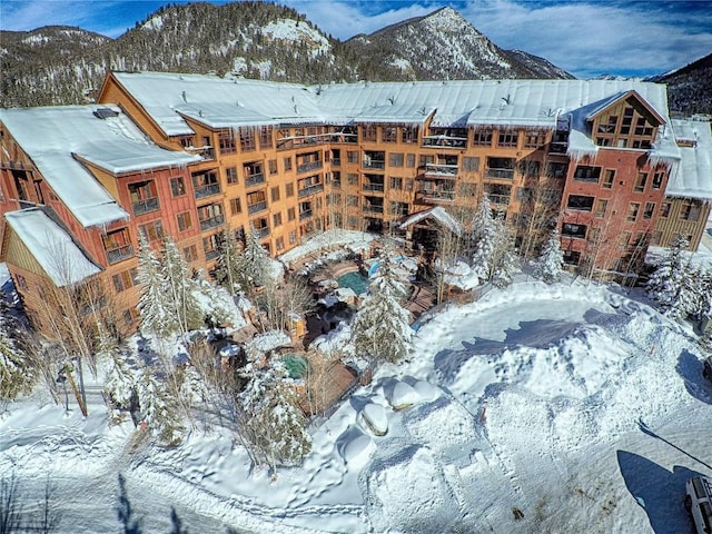 snow covered property with a mountain view