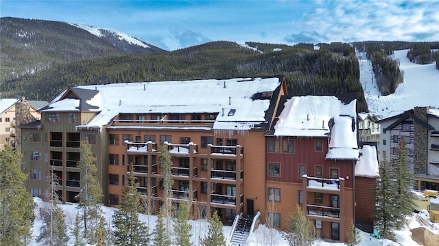 snowy aerial view with a mountain view