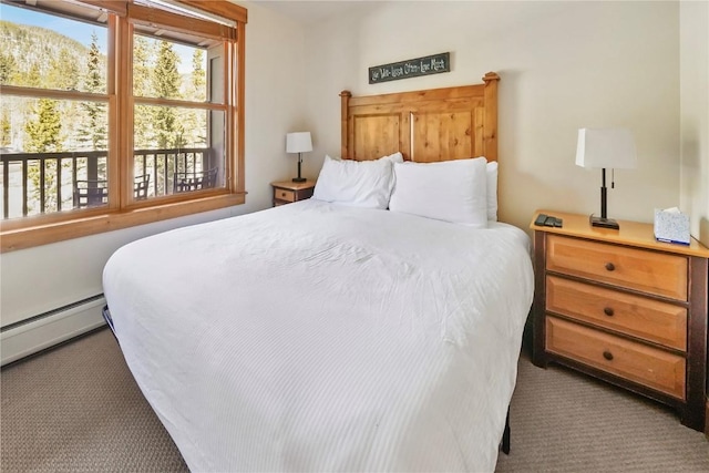 carpeted bedroom featuring a baseboard radiator