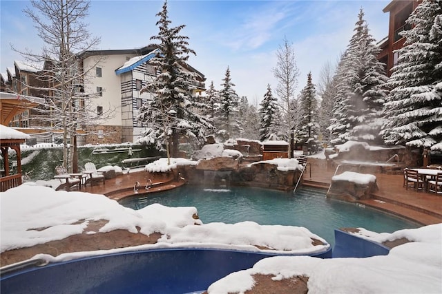 snow covered pool with a fenced in pool