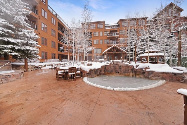 view of home's community featuring outdoor dining area and a patio area